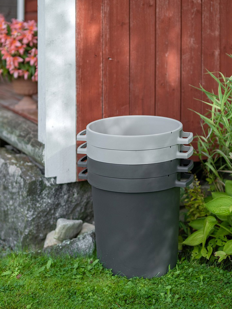 Stack of Orthex bins by a red house